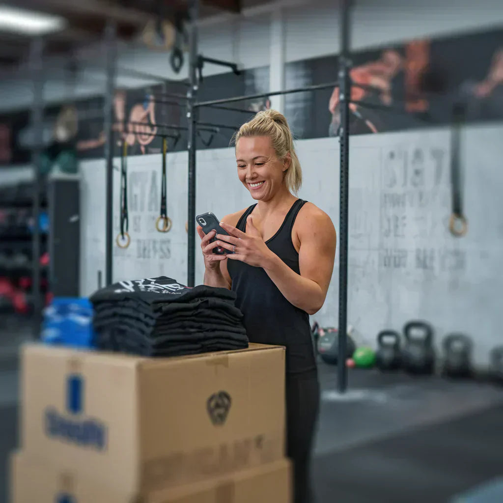 a girl laughing to read a message on cell phone