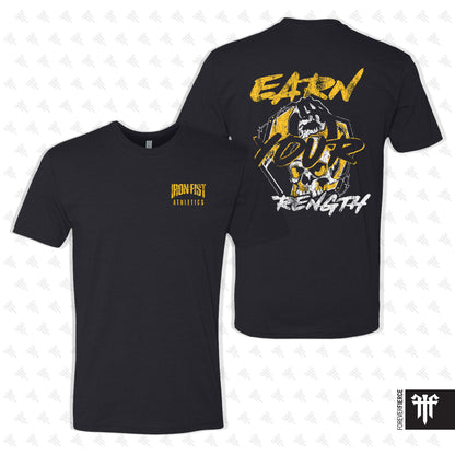 Black t-shirt with yellow and white graphics and text on a light gray background